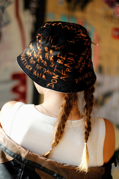 Double-sided/reversible bucked hat with hand painted/bleached elements