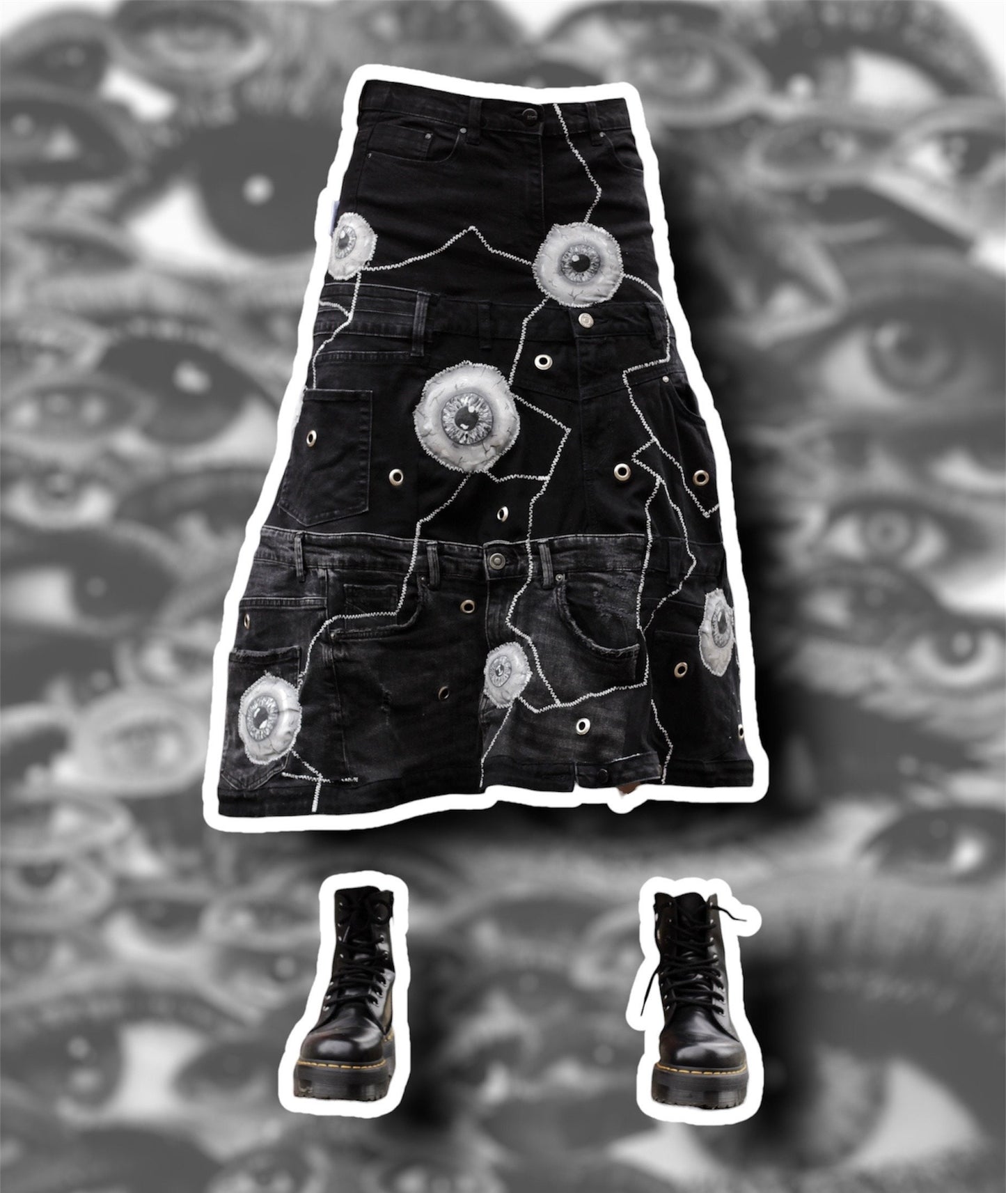 Repurposed black denim skirt with painted puffy eye balls and zig zag stitching on top