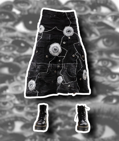 Repurposed black denim skirt with painted puffy eye balls and zig zag stitching on top