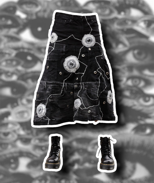 Repurposed black denim skirt with painted puffy eye balls and zig zag stitching on top