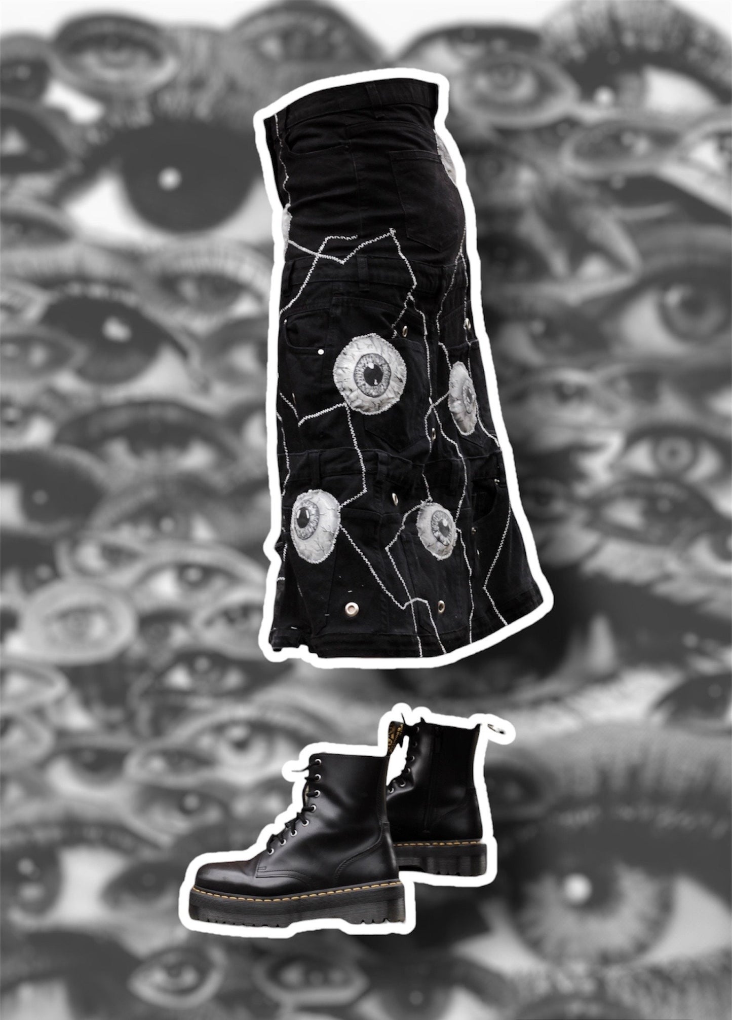 Repurposed black denim skirt with painted puffy eye balls and zig zag stitching on top