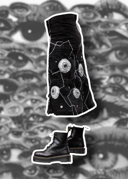 Repurposed black denim skirt with painted puffy eye balls and zig zag stitching on top