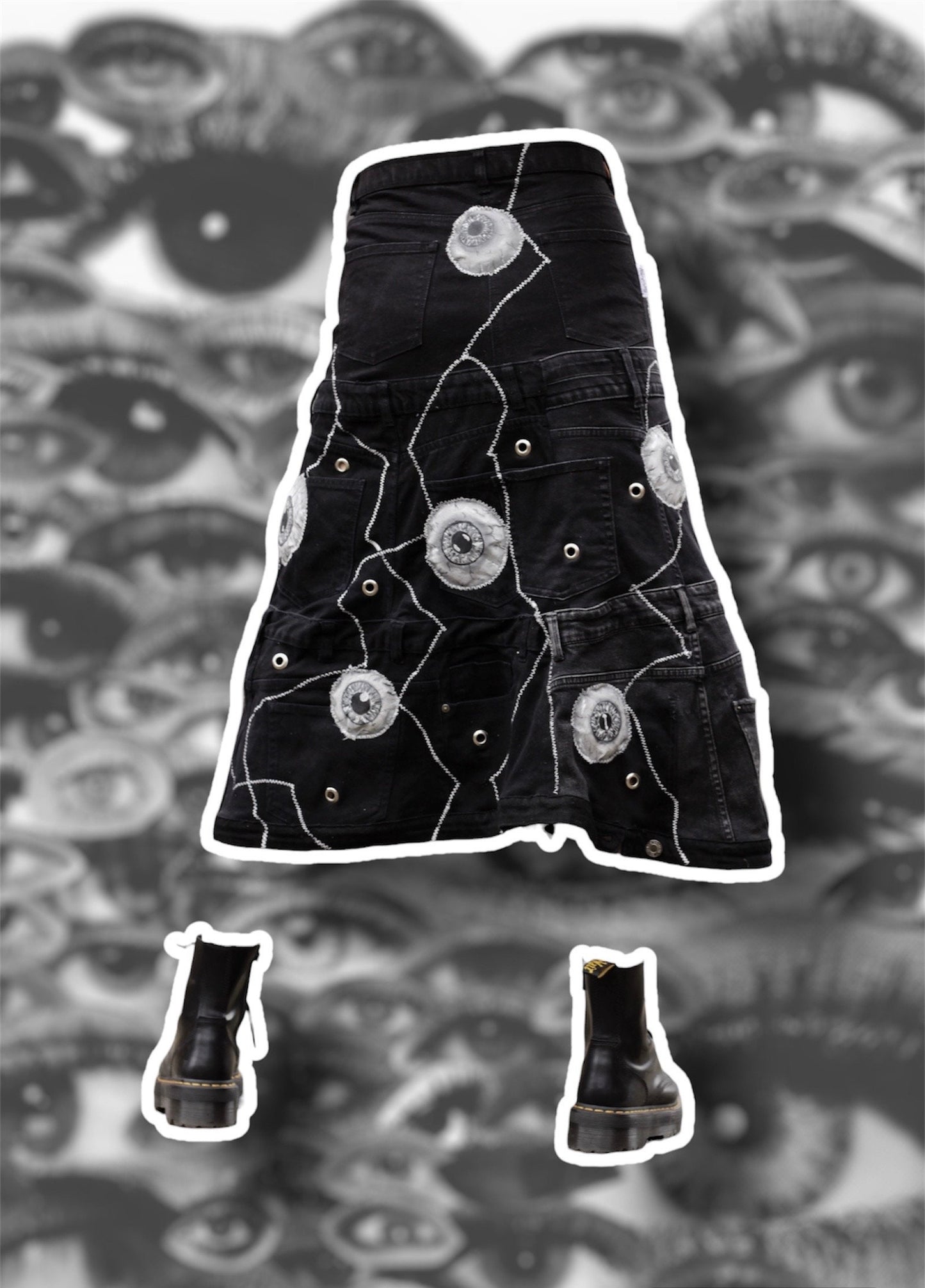 Repurposed black denim skirt with painted puffy eye balls and zig zag stitching on top