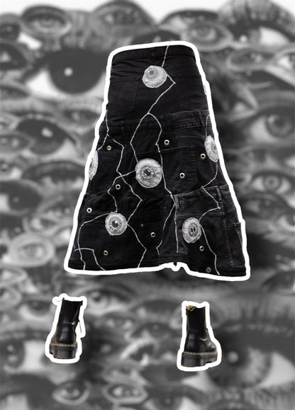 Repurposed black denim skirt with painted puffy eye balls and zig zag stitching on top