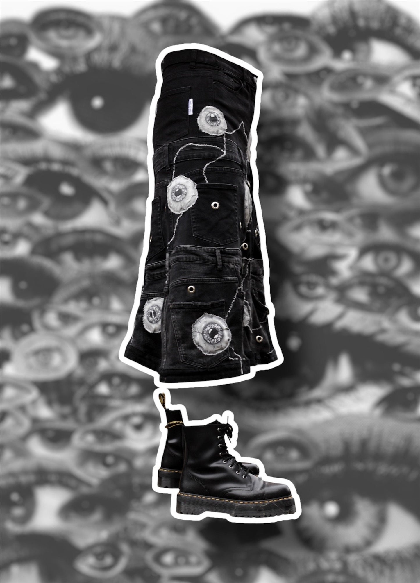 Repurposed black denim skirt with painted puffy eye balls and zig zag stitching on top