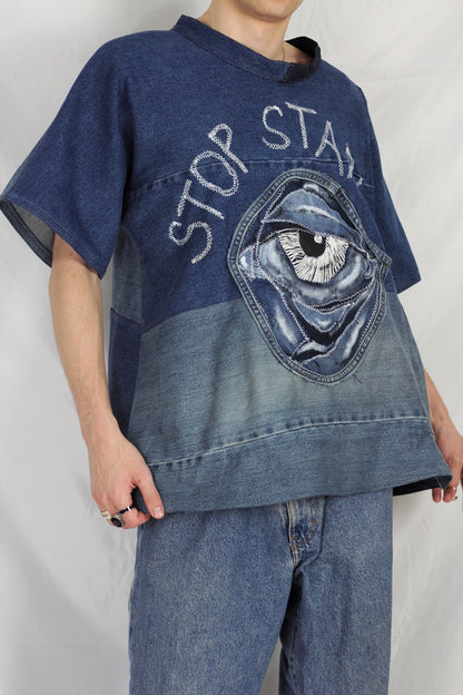 Baggy blue denim T-shirt with textured “Stop staring” title