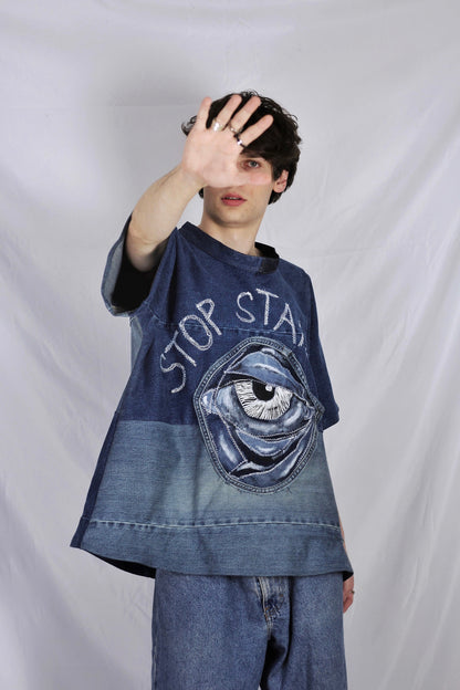 Baggy blue denim T-shirt with textured “Stop staring” title