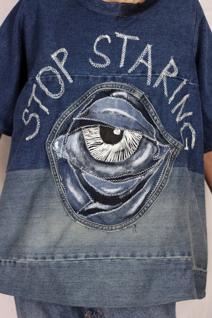 Baggy blue denim T-shirt with textured “Stop staring” title